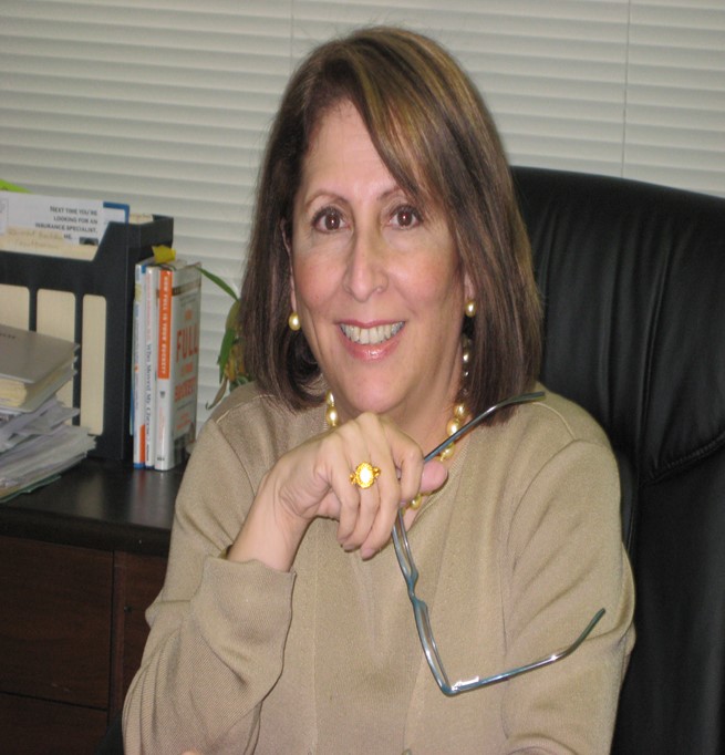 photo of Lillian Romero at her desk